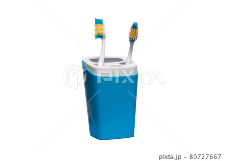 Two toothbrushes in glass isolated on white 80727667