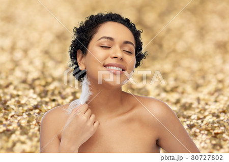 happy african american woman with feather 80727802
