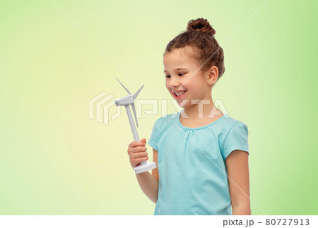 smiling girl with toy wind turbine smiling girl with toy wind turbine 80727913
