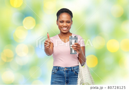 woman with tumbler and food in string bag woman with tumbler and food in string bag 80728125