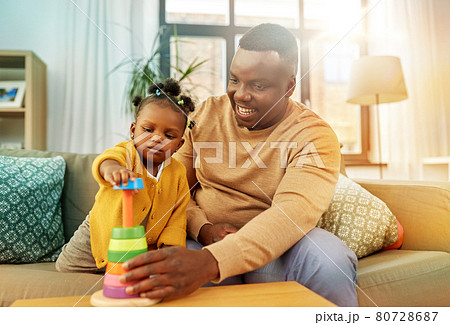 african family playing with baby daughter at home 80728687