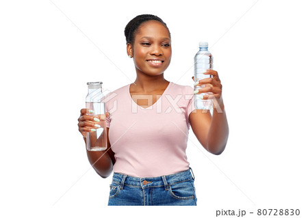 happy woman with plastic and glass bottle of water happy woman with plastic and glass bottle of water 80728830
