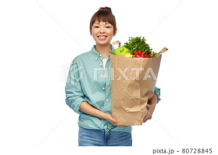 happy asian woman with food in paper shopping bag 80728845