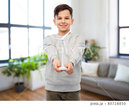 smiling boy with toy wind turbine smiling boy with toy wind turbine 80728850