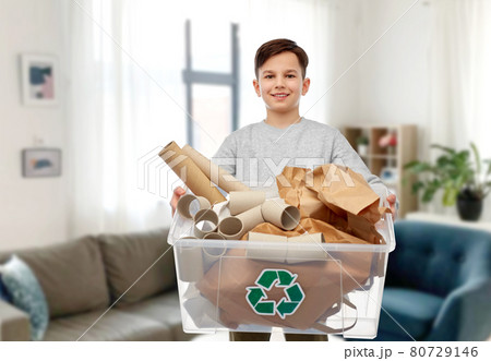 smiling boy sorting paper waste smiling boy sorting paper waste 80729146