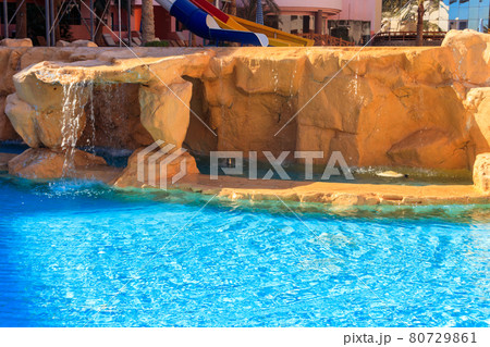 Beautiful small waterfall in the swimming pool Beautiful small waterfall in the swimming pool 80729861