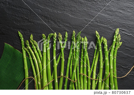 Asparagus from the garden on black stone background Asparagus from the garden on black stone background 80730637