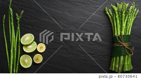 Asparagus from the garden on black stone background Asparagus from the garden on black stone background 80730641