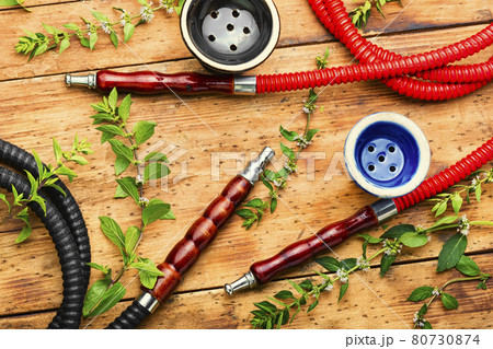 Smoking hookah with fresh mint Smoking hookah with fresh mint 80730874