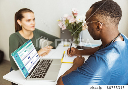 At the doctor. Young woman and doctor, therapeutic or medical advisor discuss health problems at medical office. Concept of healthcare, care, medicine and professional occupation 80733313