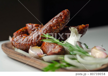 Traditional Polish juniper sausage on a wooden plate, luxury smoked product Traditional Polish juniper sausage on a wooden plate, luxury smoked product 80739058