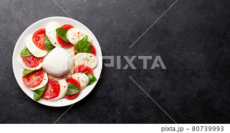 Caprese salad with mozzarella, basil and garden tomatoes Caprese salad with mozzarella, basil and garden tomatoes 80739993