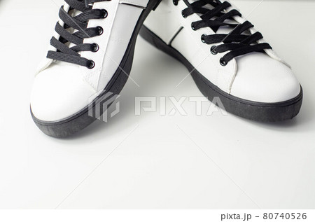 White sneakers with black laces, classic sports shoes White sneakers with black laces, classic sports shoes 80740526