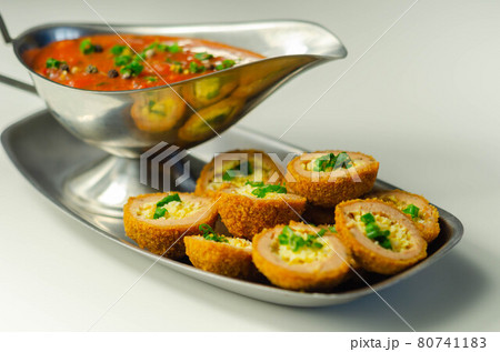 Mini scotch eggs with tomato sauce served on the silver plate 80741183