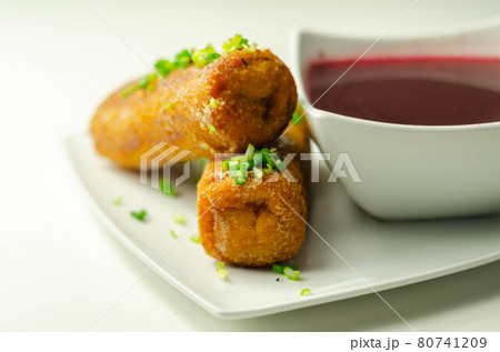 Delicious croquettes with sauerkraut and mushrooms served with hot red borscht 80741209