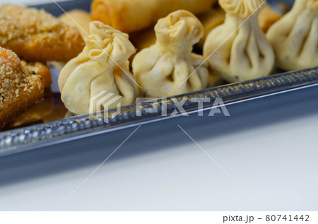 Sweet and sour vegetable wontons, Traditional chinese dumplings filled with bean sprouts, red bell peppers, carrot, cabbage and spring onions 80741442