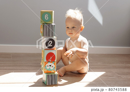 Cute little boy child playing at home with colorful cubes Cute little boy child playing at home with colorful cubes 80743588