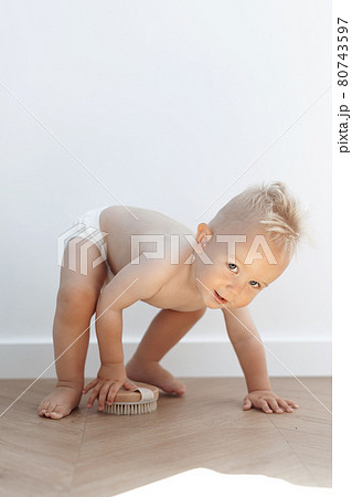 little boy is playing with a washing brush little boy is playing with a washing brush 80743597