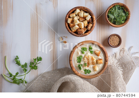 White cauliflower cream soup with croutons on wooden table with copy space 80744594