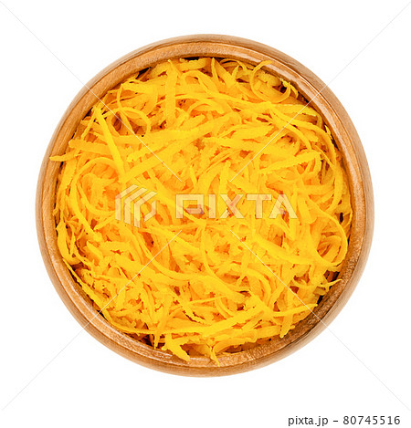 Fresh organic orange zest, orange peel strips, in a wooden bowl. Skin of ripe oranges, used for baking, or dried for tea blends. Close-up, from above, isolated on white background, macro food photo. Fresh organic orange zest, orange peel strips, in a wooden bowl. Skin of ripe oranges, used for baking, or dried for tea blends. Close-up, from above, isolated on white background, macro food photo. 80745516