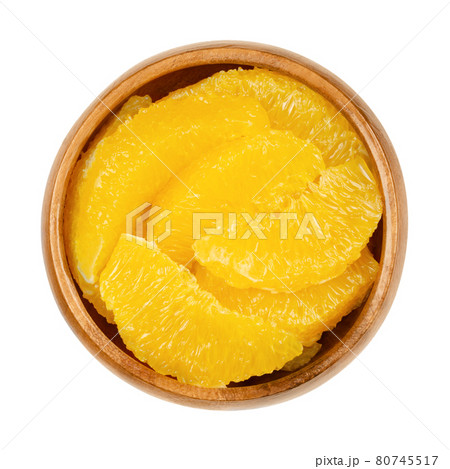 Orange slices supreme, in a wooden bowl. Fresh, ripe orange segments, cut without membranes, sweet fruit with juicy, yellow fruit flesh. Close-up from above, isolated on white background, food photo. Orange slices supreme, in a wooden bowl. Fresh, ripe orange segments, cut without membranes, sweet fruit with juicy, yellow fruit flesh. Close-up from above, isolated on white background, food photo. 80745517