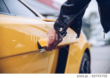 Man is reaching for the car door handle Man is reaching for the car door handle 80745708