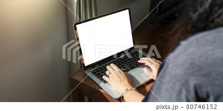 Woman working from home E learning home isolation auto quarantine woman working on laptop computer while sitting at the living room Woman working from home E learning home isolation auto quarantine woman working on laptop computer while sitting at the living room 80746152