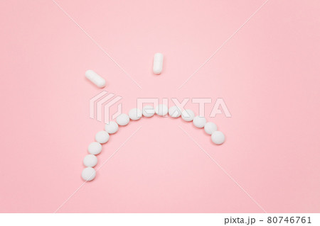 Pharma Harm. Angry Smiley Face Made from White Pills 80746761