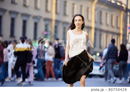 Young woman 18 years on crowded city street in evening. Young woman 18 years on crowded city street in evening. 80750429