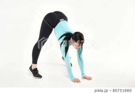 Young athletic woman making yoga and gymnastics stretching exercises isolated on white Young athletic woman making yoga and gymnastics stretching exercises isolated on white 80751660