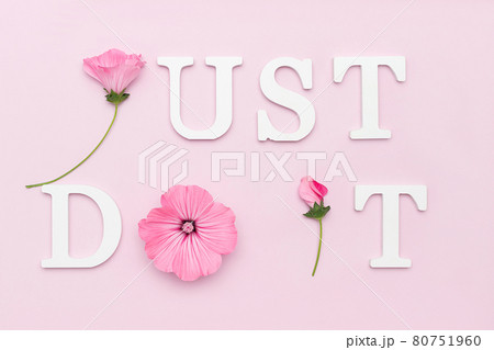 Just do it. Motivational quote from white letters and beauty natural flowers on pink background. Creative concept inspirational quote of the day 80751960