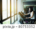 Side view of beautiful girl running on treadmill at gym 80753352