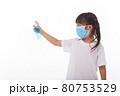 Cute Asian girl wearing a mask and washing her hands with alcohol to prevent spreading the disease on a white background. Prevention of the spread of influenza virus Coronary COVID-19 influenza 80753529