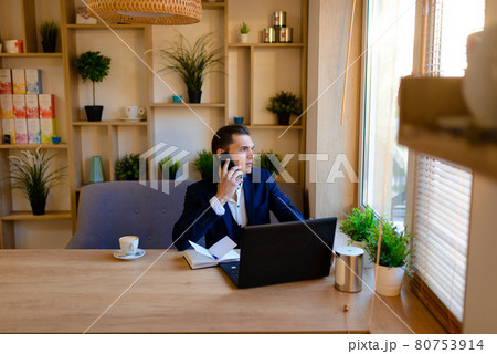 Young man on the street and in cafe with mobile phone Young man on the street and in cafe with mobile phone 80753914