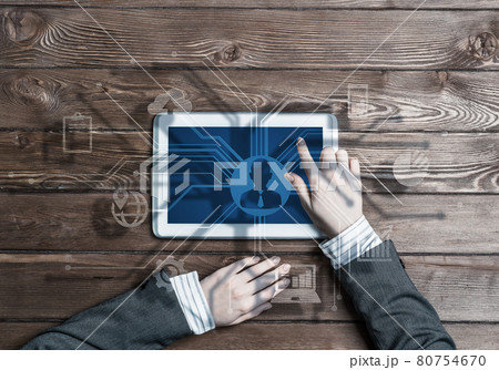 Business workplace with tablet device in female hands and media user interface 80754670
