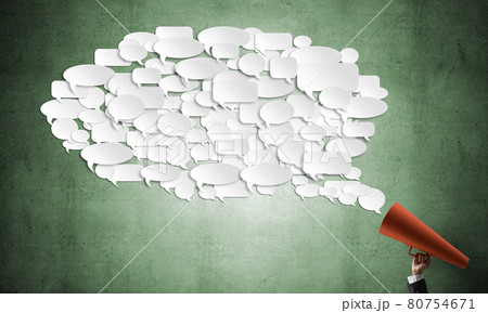Hand of businesswoman holding red paper trumpet and speech cloud coming out 80754671