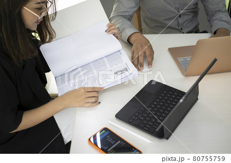 Group of business people discussing financial report together in office. Group of business people discussing financial report together in office. 80755759