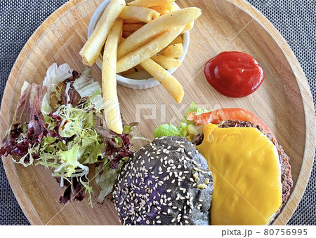American food cheese hamburgar with fries and salad on the wooden tray American food cheese hamburgar with fries and salad on the wooden tray 80756995