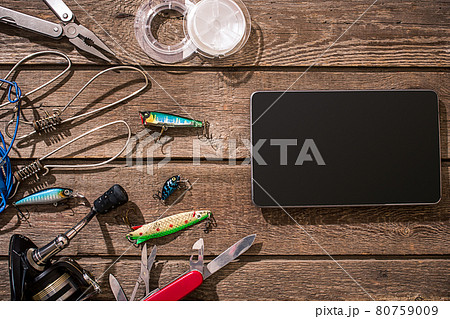 Accessories for fishing on the background of wood. Top view 80759009