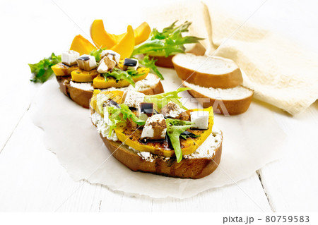 Bruschetta with pumpkin and sauce on white board Bruschetta with pumpkin and sauce on white board 80759583