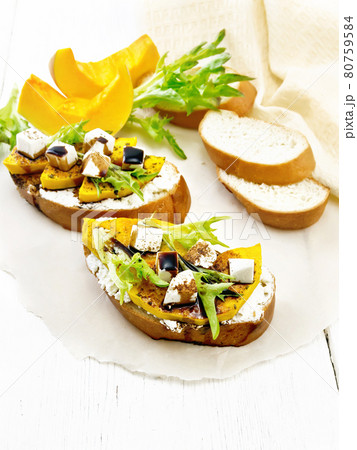 Bruschetta with pumpkin and sauce on light board 80759584