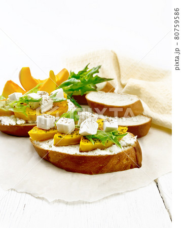Bruschetta with pumpkin and ricotta on light board 80759586
