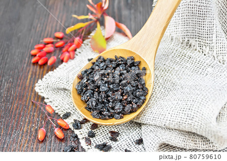 Barberry dried in spoon on dark board Barberry dried in spoon on dark board 80759610