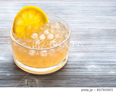 boba bubbles with lemon slice in bowl on gray 80760905