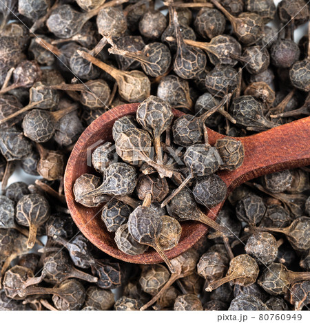 top view of spoon on pile of dried cubeb pepper top view of spoon on pile of dried cubeb pepper 80760949