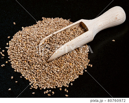 scoop on unhulled barnyard millet seeds on black 80760972