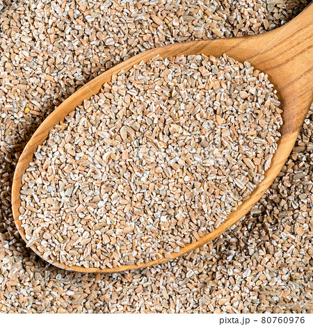 crushed rye groats in wood spoon closeup crushed rye groats in wood spoon closeup 80760976