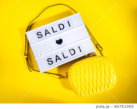 Fashion sale concept with lightbox Italian text and leather bag on yellow 80761069