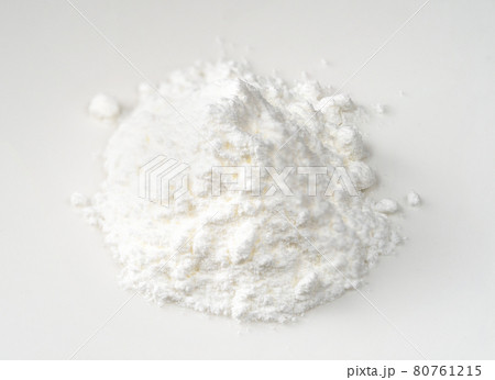 handful of baking powder closeup on white 80761215