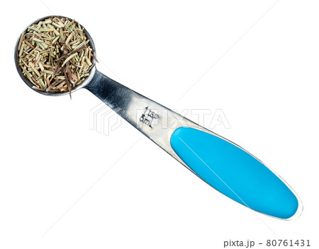 dried rosemary leaves in measuring teaspoon cutout 80761431